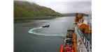 On June 25, 2011, a tug boat headed back to Dutch Harbor, Alaska, after guiding the U.S. Coast Guard Cutter Healy away from port as part of the ICESCAPE mission, or "Impacts of Climate on Ecosystems and Chemistry of the Arctic Pacific Environment."