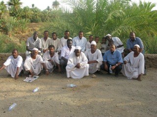 Health workers pose with villagers from Abu Hamad, Sudan, where a concerted and coordinated effort stopped the transmission of river blindness.