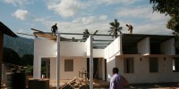 Dr. Lusingu inspects the construction of a clinical research center adjacent to the Korogwe district hospital. Building began on 2007 with funds from the Malaria Vaccine Initiative and the Malaria Clinical Trials Alliance.