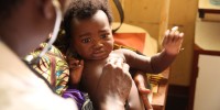 Dr. Lusingu attending to children with malaria in the pediatric ward of the Korogwe District Hospital in Tanzania.