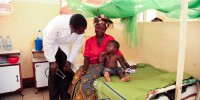 Dr. Lusingu attending to children with malaria in the pediatric ward of the Korogwe District Hospital in Tanzania.