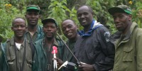 Jean-Felix Kinani (darts in hand) with his team