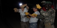 Vodzak, Reeder, and wildlife officer Wurube Alison retrieve bats from a triple-high mist net after a successful night of trapping. Courtesy of DeeAnn Reeder