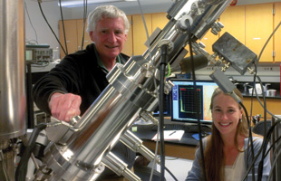 IMAGING LIPIDS WITH MASS SPEC: Nick Winograd of Penn State University and Anna Bloom, a graduate student, obtain images of lipids with a SIMS machine. The big steel column in the foreground is the C60 ion source used to ionize lipids in tissue slices.